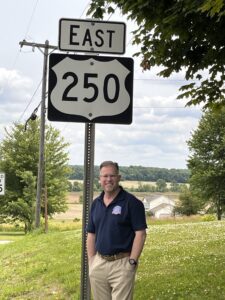 Photo, Todd Kleismit, standing beneath Route 250 East