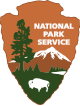 Arrowhead shaped logo with drawing of buffalo, mountain and tree for National Park Service